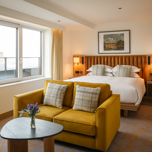 Kilkenny Suites with City View - Yellow Sofa in Hotel Bedroom